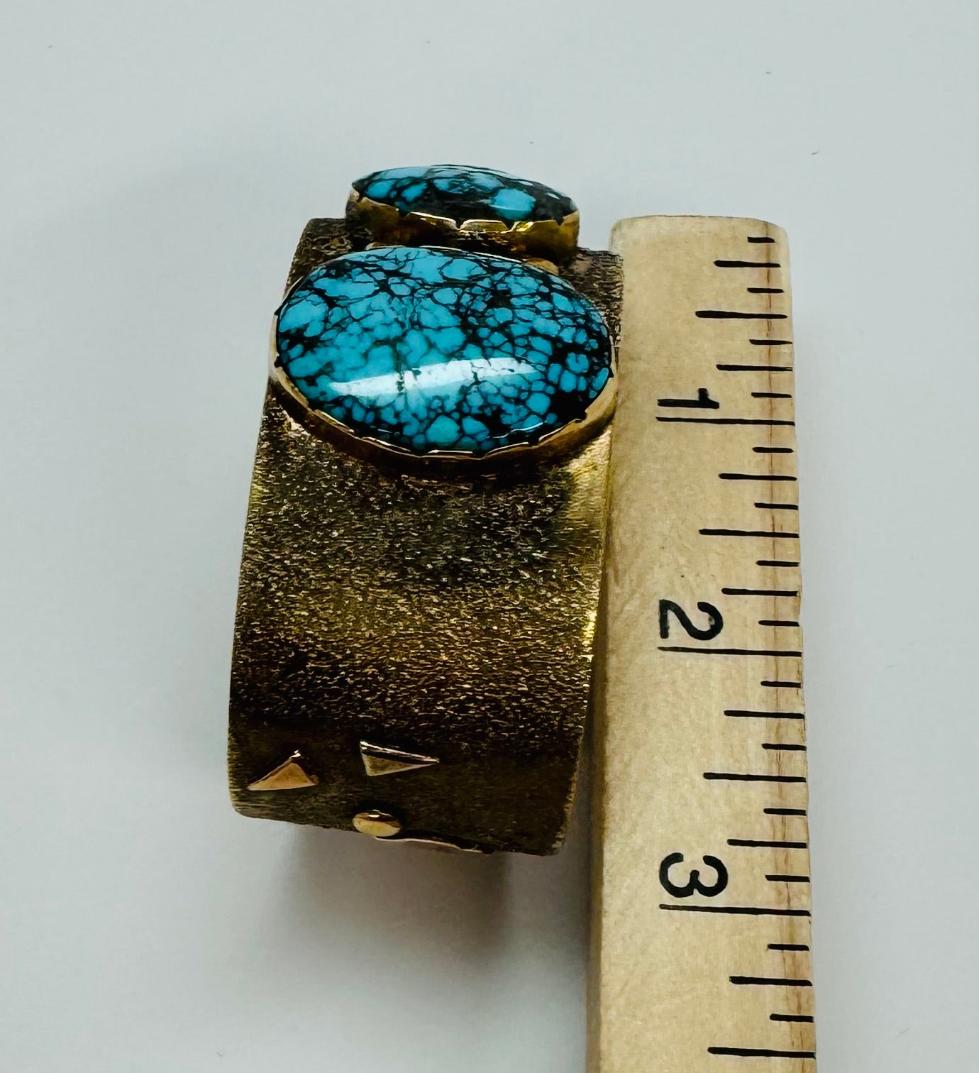 14k Gold Cuff Story Teller Bracelet with Three Turquoise Stones.