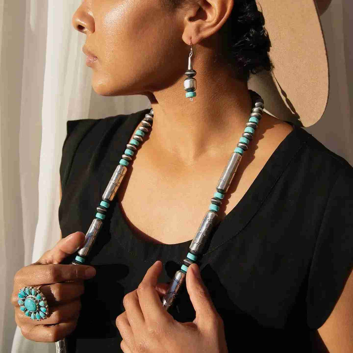 Woman wearing turquoise and silver Southwestern jewelry
